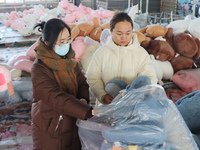 Workers are processing plush toys for export at a toy factory in Lianyungang City, East China's Jiangsu Province, on December 28, 2023. (