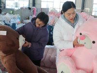 Workers are processing plush toys for export at a toy factory in Lianyungang City, East China's Jiangsu Province, on December 28, 2023. (