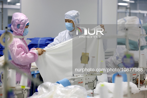 Qiu Zhanglei, a master's student, is checking the quality of medical products being produced in a workshop of a private medical device manuf...