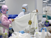 Qiu Zhanglei, a master's student, is checking the quality of medical products being produced in a workshop of a private medical device manuf...