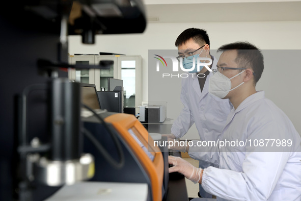 Two graduate students are analyzing data on biodegradable materials at a private enterprise laboratory in Xiwangzhuang town, Zaozhuang, Chin...