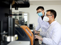 Two graduate students are analyzing data on biodegradable materials at a private enterprise laboratory in Xiwangzhuang town, Zaozhuang, Chin...