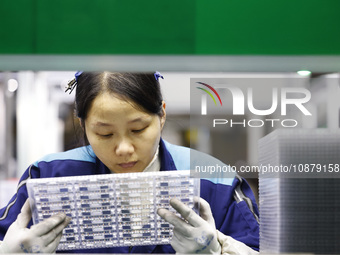 A worker is working on the production line of an electronic components company in Suqian, Jiangsu Province, China, on December 29, 2023. (