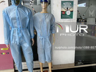 Mannequins are standing outside a shop that is selling face masks, hand sanitizer, and other personal protective equipment to help protect a...