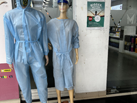 Mannequins are standing outside a shop that is selling face masks, hand sanitizer, and other personal protective equipment to help protect a...