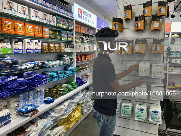 A man is purchasing N99 face masks at a shop that sells face masks, hand sanitizer, and other personal protective equipment to help protect...