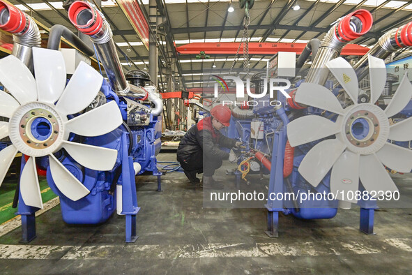 A worker is assembling a generator at a manufacturing enterprise in Qingzhou, East China's Shandong province, on December 31, 2023. 