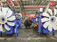 A worker is assembling a generator at a manufacturing enterprise in Qingzhou, East China's Shandong province, on December 31, 2023. (