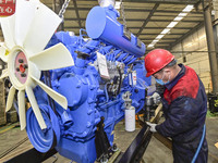 A worker is assembling a generator at a manufacturing enterprise in Qingzhou, East China's Shandong province, on December 31, 2023. (