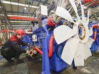 A worker is assembling a generator at a manufacturing enterprise in Qingzhou, East China's Shandong province, on December 31, 2023. (