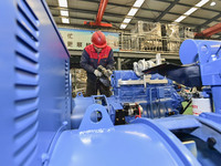 A worker is assembling a generator at a manufacturing enterprise in Qingzhou, East China's Shandong province, on December 31, 2023. (