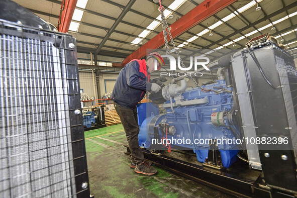 A worker is assembling a generator at a manufacturing enterprise in Qingzhou, East China's Shandong province, on December 31, 2023. 