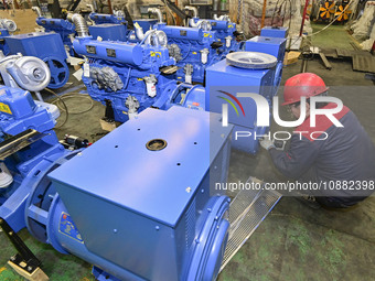 A worker is assembling a generator at a manufacturing enterprise in Qingzhou, East China's Shandong province, on December 31, 2023. (