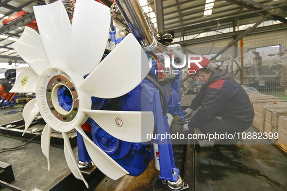 A worker is assembling a generator at a manufacturing enterprise in Qingzhou, East China's Shandong province, on December 31, 2023. 