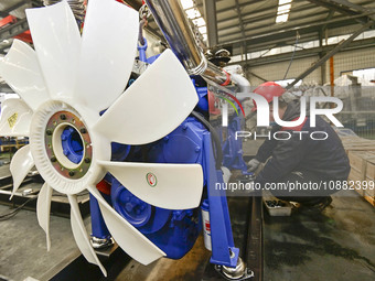 A worker is assembling a generator at a manufacturing enterprise in Qingzhou, East China's Shandong province, on December 31, 2023. (