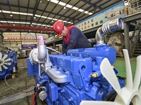 A worker is assembling a generator at a manufacturing enterprise in Qingzhou, East China's Shandong province, on December 31, 2023. (