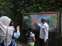 A guide is accompanying tourists as they visit the Japanese tunnel, also known as Lobang Jepang, at the historical tourist attraction in Buk...