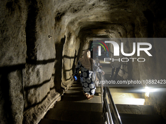 Visitors are walking through the Lobang Jepang (Japanese Tunnel), a historical tourist attraction in Bukittinggi, West Sumatra, Indonesia, o...