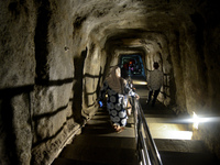 Visitors are walking through the Lobang Jepang (Japanese Tunnel), a historical tourist attraction in Bukittinggi, West Sumatra, Indonesia, o...