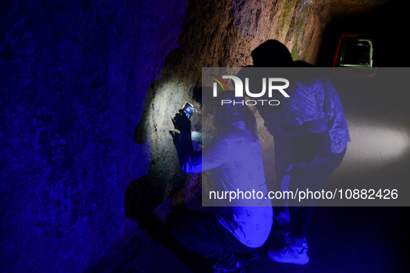 A visitor is exploring the Lobang Jepang (Japanese tunnel), a historical tourist attraction in Bukittinggi, West Sumatra, Indonesia, on Dece...