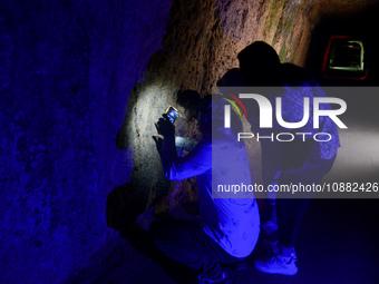 A visitor is exploring the Lobang Jepang (Japanese tunnel), a historical tourist attraction in Bukittinggi, West Sumatra, Indonesia, on Dece...