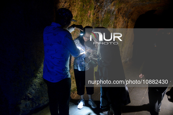 A visitor is exploring the Lobang Jepang (Japanese tunnel), a historical tourist attraction in Bukittinggi, West Sumatra, Indonesia, on Dece...