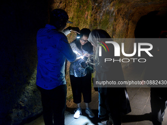 A visitor is exploring the Lobang Jepang (Japanese tunnel), a historical tourist attraction in Bukittinggi, West Sumatra, Indonesia, on Dece...