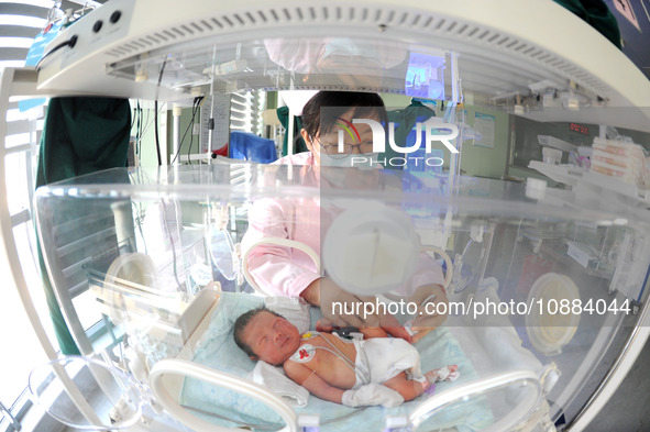 A medical worker is taking care of newborns at Dongfang Hospital in Lianyungang, China, on January 1, 2024. 