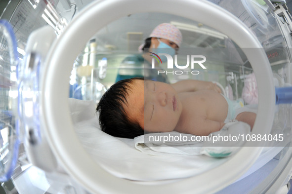 A medical worker is taking care of newborns at Dongfang Hospital in Lianyungang, China, on January 1, 2024. 