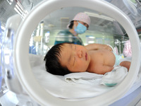 A medical worker is taking care of newborns at Dongfang Hospital in Lianyungang, China, on January 1, 2024. (