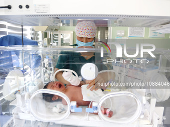 A medical worker is taking care of newborns at Dongfang Hospital in Lianyungang, China, on January 1, 2024. (