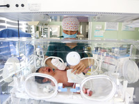 A medical worker is taking care of newborns at Dongfang Hospital in Lianyungang, China, on January 1, 2024. (