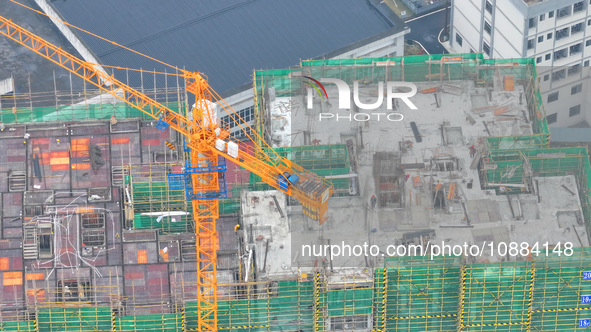 Workers are working on a community construction site in Jinping County, Guizhou Province, China, on January 1, 2023. 