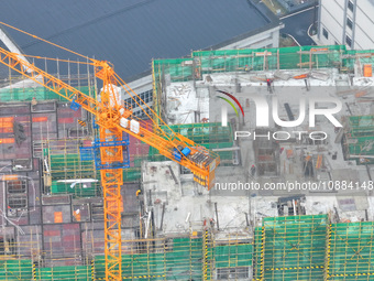 Workers are working on a community construction site in Jinping County, Guizhou Province, China, on January 1, 2023. (