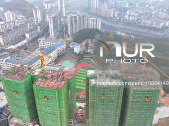 Workers are working on a community construction site in Jinping County, Guizhou Province, China, on January 1, 2023. (