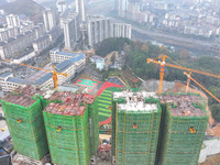 Workers are working on a community construction site in Jinping County, Guizhou Province, China, on January 1, 2023. (