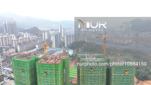 Workers are working on a community construction site in Jinping County, Guizhou Province, China, on January 1, 2023. 