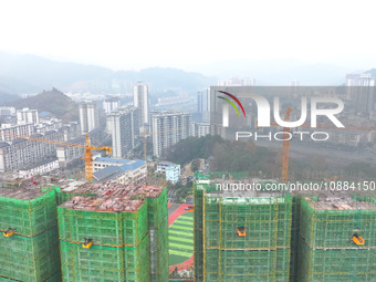 Workers are working on a community construction site in Jinping County, Guizhou Province, China, on January 1, 2023. (