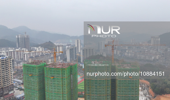 Workers are working on a community construction site in Jinping County, Guizhou Province, China, on January 1, 2023. 