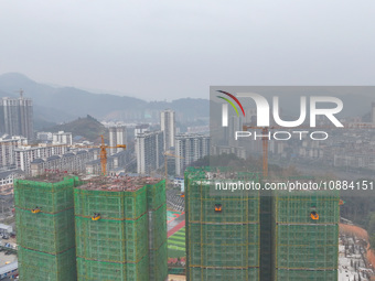 Workers are working on a community construction site in Jinping County, Guizhou Province, China, on January 1, 2023. (