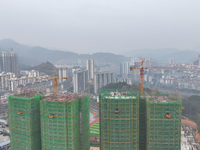 Workers are working on a community construction site in Jinping County, Guizhou Province, China, on January 1, 2023. (