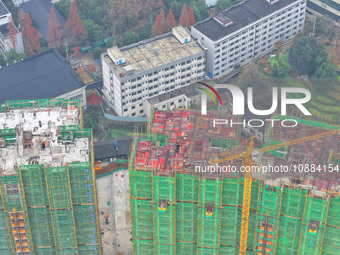 Workers are working on a community construction site in Jinping County, Guizhou Province, China, on January 1, 2023. (