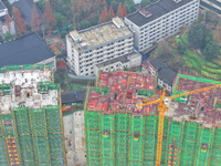 Workers are working on a community construction site in Jinping County, Guizhou Province, China, on January 1, 2023. (