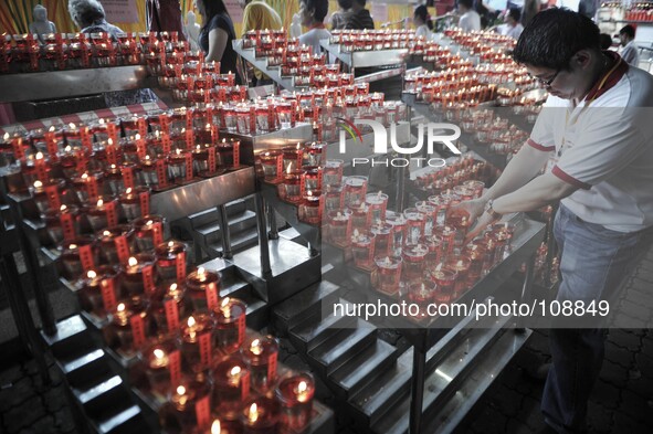 A Buddhist devotee places an oil lamp  during Vesak Day celebrations at a Buddhist temple in Kuala Lumpur, Malaysia on May 13, 2014.

Photo:...