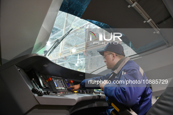 Workers are inspecting an EMU train at the inspection depot of the Nanjing South Bullet Train station in Nanjing, Jiangsu Province, China, o...