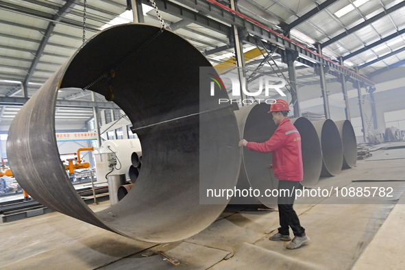 A worker is lifting equipment at a workshop of an equipment manufacturing enterprise in the Qingzhou Economic Development Zone in Qingzhou,...