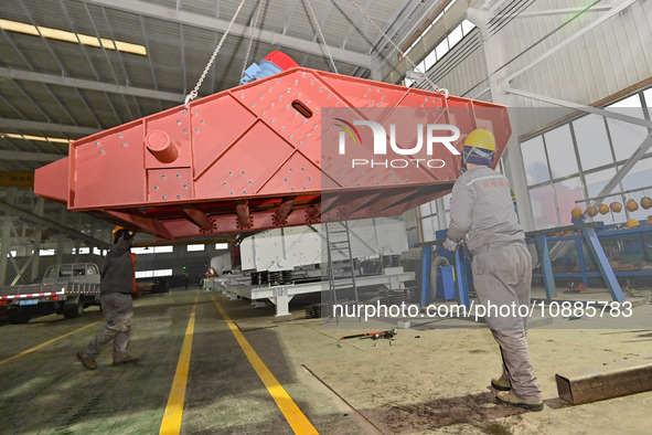 A worker is lifting equipment at a workshop of an equipment manufacturing enterprise in the Qingzhou Economic Development Zone in Qingzhou,...