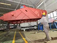 A worker is lifting equipment at a workshop of an equipment manufacturing enterprise in the Qingzhou Economic Development Zone in Qingzhou,...