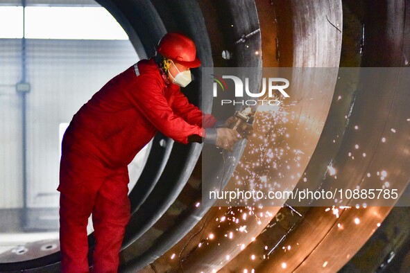 A worker is grinding at a workshop of an equipment manufacturing company in the Qingzhou Economic Development Zone, in Qingzhou, China, on J...