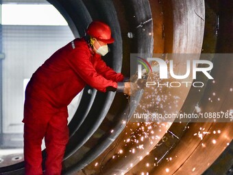 A worker is grinding at a workshop of an equipment manufacturing company in the Qingzhou Economic Development Zone, in Qingzhou, China, on J...